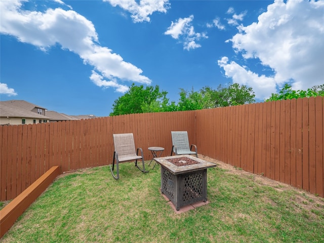 view of yard with a fenced backyard and an outdoor fire pit