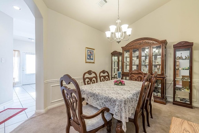 518 Walnut Heights Blvd, New Braunfels, TX 78130 - dining room featuring arched walkways, a chandelier, light carpet, wainscoting, and lofted ceiling