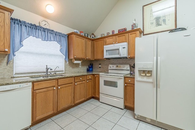 kitchen with a sink, white appliances, light tile patterned floors, lofted ceiling, and backsplash