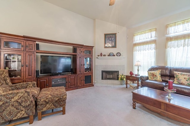 carpeted living area featuring a fireplace and vaulted ceiling