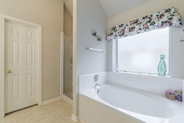 full bath with baseboards, lofted ceiling, a bath, and a shower stall