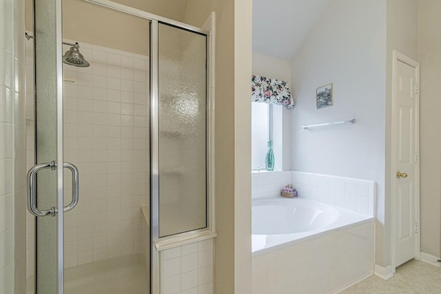 full bathroom with lofted ceiling, a shower stall, and a garden tub