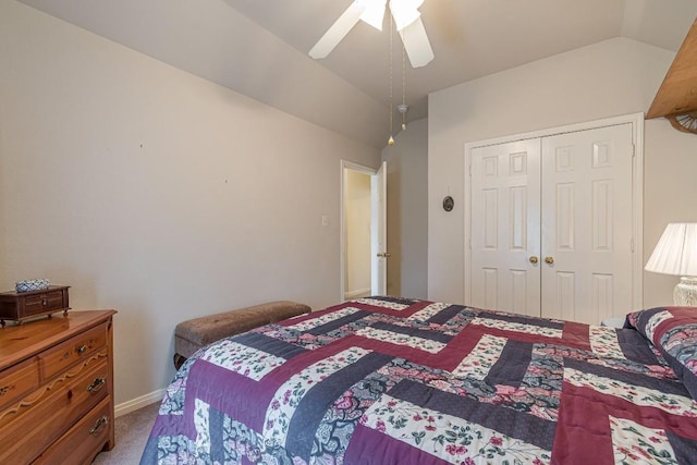 carpeted bedroom with a ceiling fan, baseboards, lofted ceiling, and a closet