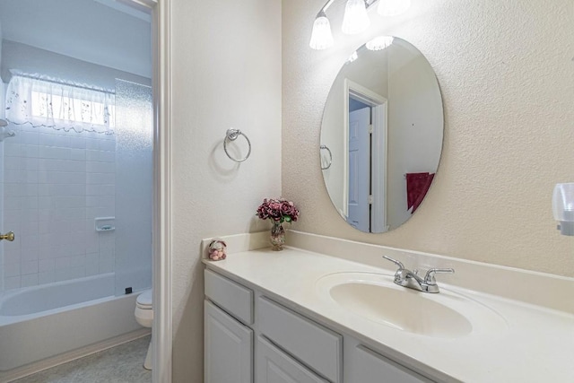 full bathroom with toilet, a textured wall, tub / shower combination, and vanity