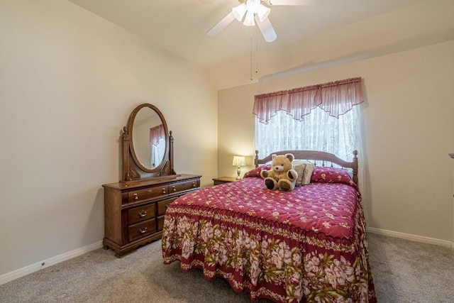 bedroom with a ceiling fan, baseboards, vaulted ceiling, and light carpet