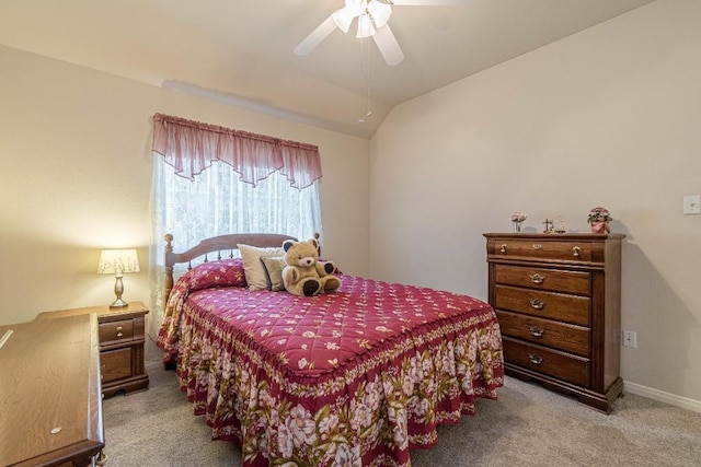 carpeted bedroom featuring a ceiling fan and vaulted ceiling