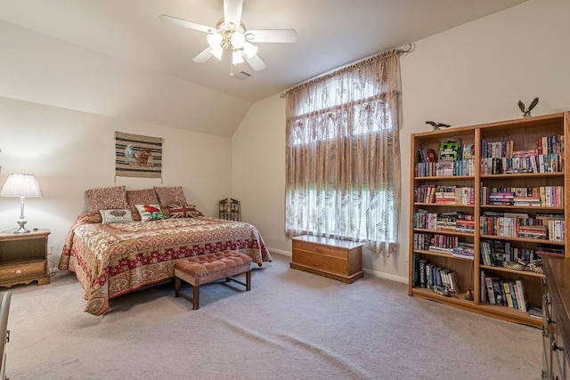 carpeted bedroom with a ceiling fan, baseboards, vaulted ceiling, and visible vents