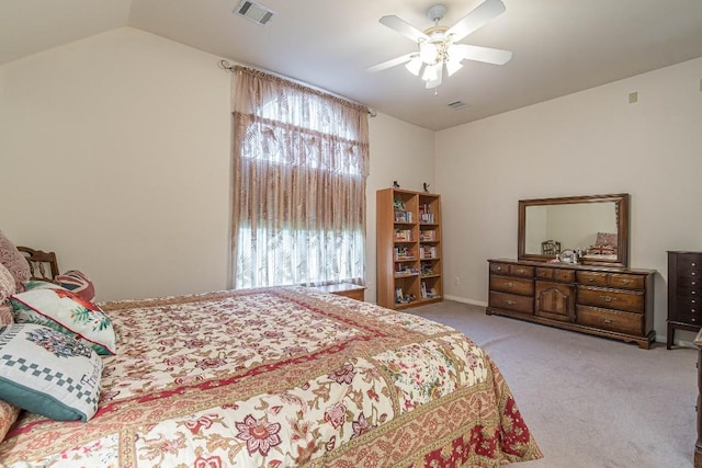 carpeted bedroom featuring visible vents, a ceiling fan, and vaulted ceiling
