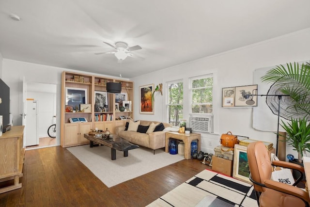 living room featuring a ceiling fan, ornamental molding, wood finished floors, and cooling unit