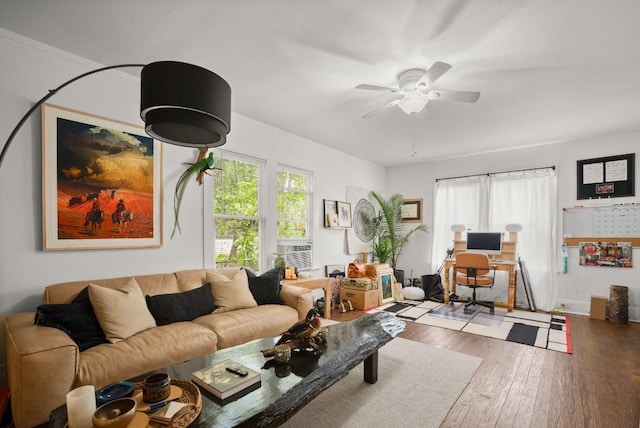 living area with wood-type flooring and a ceiling fan