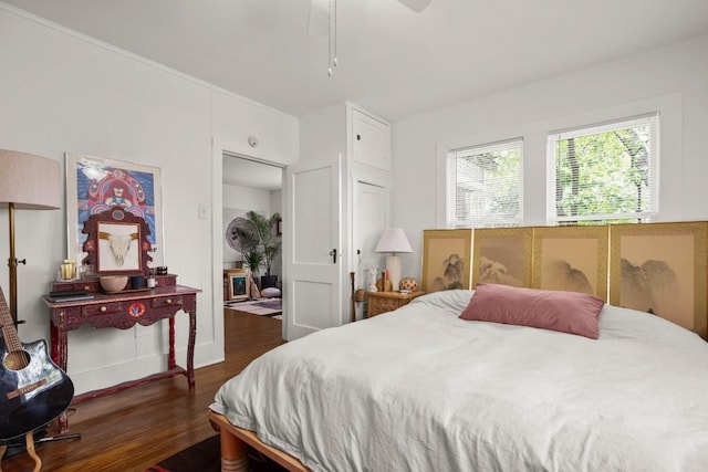 bedroom with dark wood-type flooring and a ceiling fan