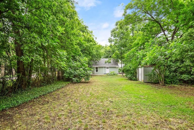 view of yard with an outbuilding and a storage shed