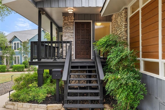 1712 Mccoy Pl, Georgetown, TX 78626 - view of exterior entry featuring stone siding, covered porch, and board and batten siding