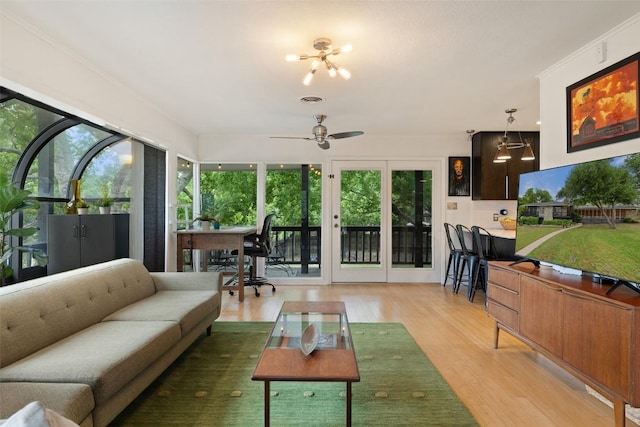 1712 Mccoy Pl, Georgetown, TX 78626 - living room featuring light wood-style flooring, healthy amount of natural light, a chandelier, and ceiling fan