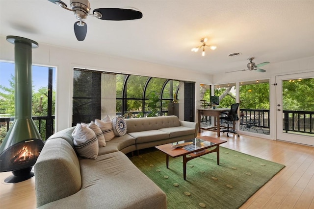 1712 Mccoy Pl, Georgetown, TX 78626 - living room with ceiling fan, a wood stove, and wood finished floors