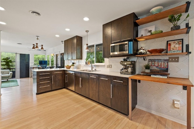 1712 Mccoy Pl, Georgetown, TX 78626 - kitchen featuring stainless steel appliances, dark brown cabinetry, light wood finished floors, light countertops, and recessed lighting