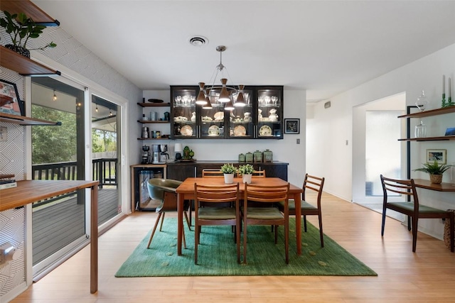 1712 Mccoy Pl, Georgetown, TX 78626 - dining space featuring light wood-style floors, a chandelier, and wine cooler