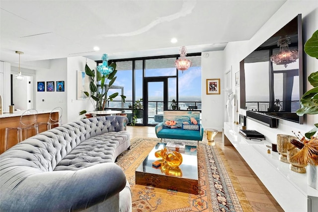 living area featuring baseboards, recessed lighting, wood finished floors, and expansive windows
