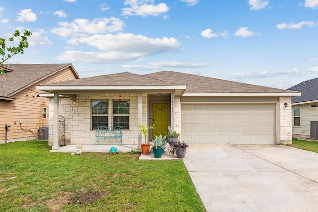 single story home featuring covered porch, a front yard, concrete driveway, an attached garage, and stone siding