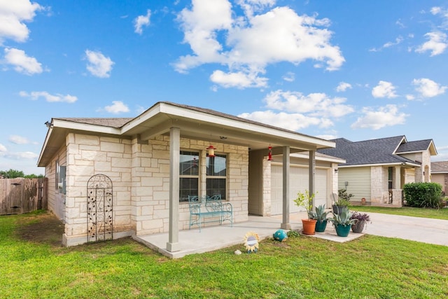 12717 Casting Dr, Manor, TX 78653 - single story home featuring covered porch, concrete driveway, stone siding, an attached garage, and a shingled roof