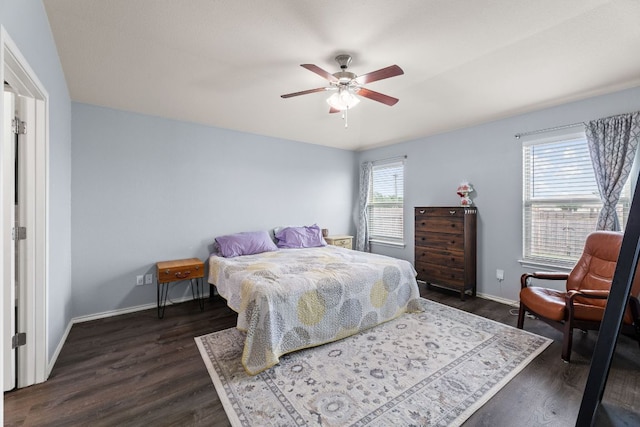 bedroom featuring baseboards, a ceiling fan, and dark wood-style flooring