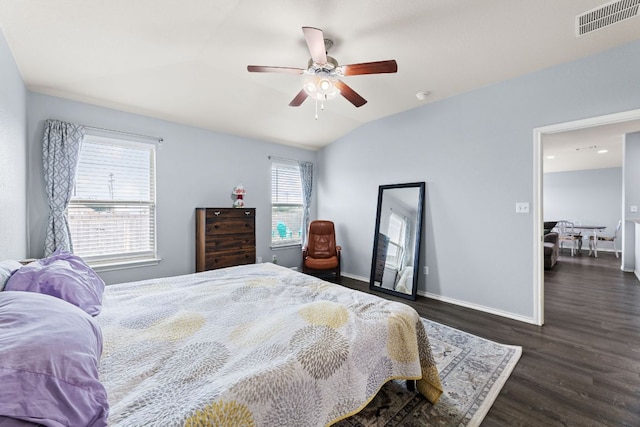 bedroom with visible vents, baseboards, dark wood-style floors, a ceiling fan, and vaulted ceiling