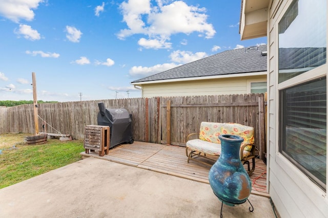 view of patio / terrace featuring a fenced backyard, a wooden deck, and grilling area