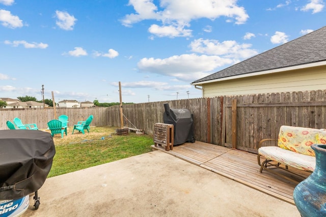 view of patio with a fenced backyard, area for grilling, and a deck