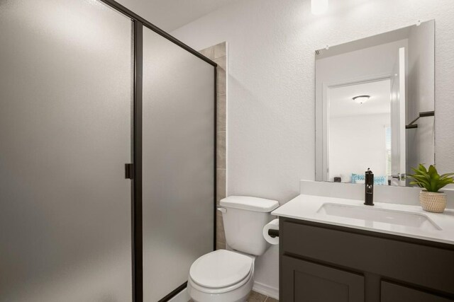 1625 Stinnett Dr, Leander, TX 78641 - full bath featuring toilet, a shower stall, and vanity