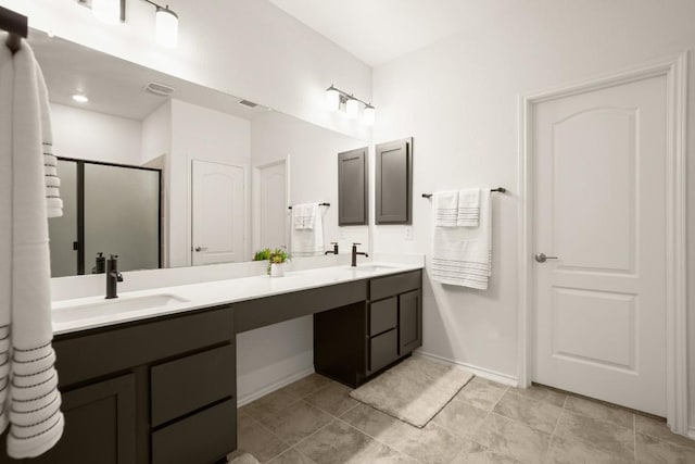 1625 Stinnett Dr, Leander, TX 78641 - bathroom featuring double vanity, baseboards, a shower stall, and a sink