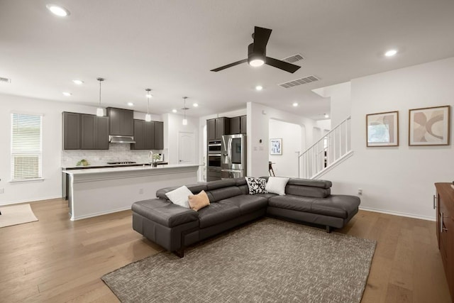 1625 Stinnett Dr, Leander, TX 78641 - living area with a ceiling fan, visible vents, recessed lighting, and light wood-style floors