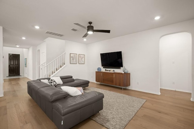 1625 Stinnett Dr, Leander, TX 78641 - living room with visible vents, arched walkways, recessed lighting, and stairway