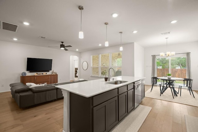 1625 Stinnett Dr, Leander, TX 78641 - kitchen with visible vents, a sink, arched walkways, and light countertops