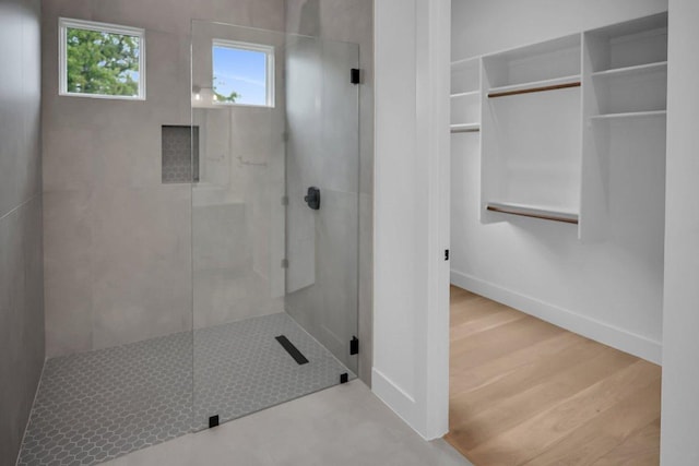 309 Alabaster, Horseshoe Bay, TX 78657 - bathroom with a walk in shower and baseboards