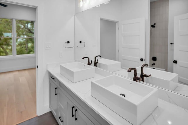 309 Alabaster, Horseshoe Bay, TX 78657 - full bathroom with double vanity, a sink, and wood finished floors