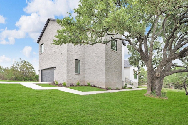 309 Alabaster, Horseshoe Bay, TX 78657 - view of property exterior with an attached garage, a lawn, and a standing seam roof