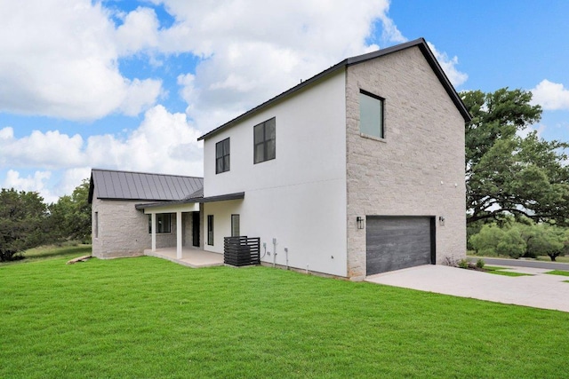309 Alabaster, Horseshoe Bay, TX 78657 - rear view of property with an attached garage, stone siding, concrete driveway, a lawn, and metal roof