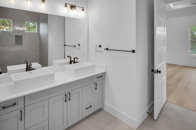 309 Alabaster, Horseshoe Bay, TX 78657 - bathroom with a sink, baseboards, and double vanity