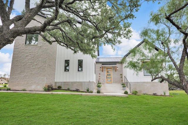 309 Alabaster, Horseshoe Bay, TX 78657 - modern farmhouse featuring board and batten siding, a standing seam roof, metal roof, and a front lawn