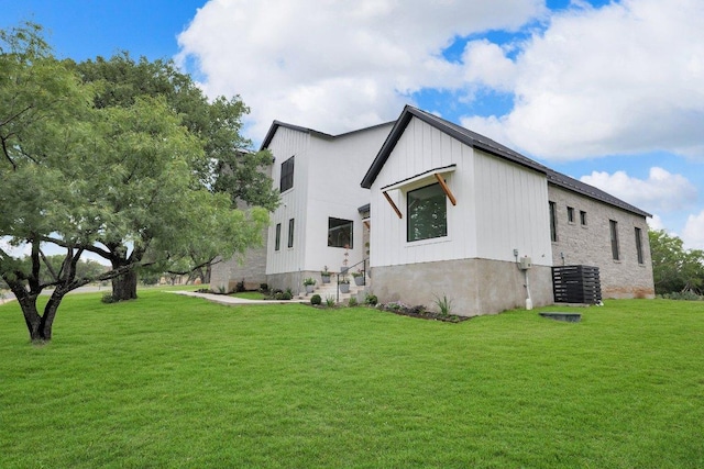 309 Alabaster, Horseshoe Bay, TX 78657 - view of side of home with board and batten siding and a yard