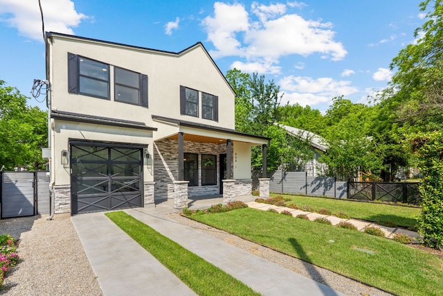 view of front facade with driveway, a front yard, an attached garage, stone siding, and stucco siding
