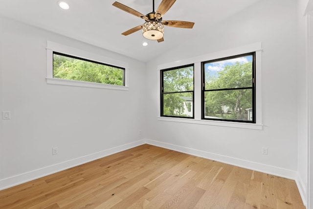 unfurnished room featuring recessed lighting, baseboards, light wood-style flooring, and lofted ceiling