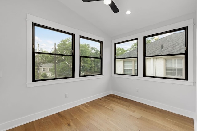 empty room with ceiling fan, baseboards, lofted ceiling, light wood-style floors, and recessed lighting