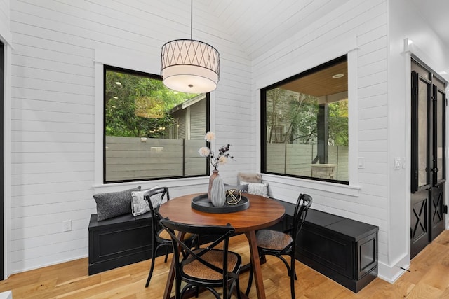 408 W 34th St, Austin, TX 78705 - dining room with healthy amount of natural light, wooden walls, and wood finished floors