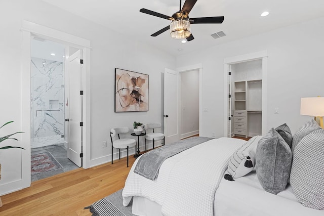 408 W 34th St, Austin, TX 78705 - bedroom with light wood finished floors, recessed lighting, a walk in closet, a ceiling fan, and connected bathroom