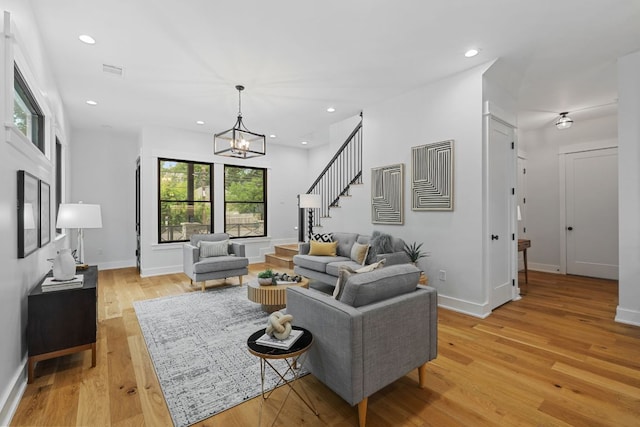 408 W 34th St, Austin, TX 78705 - living room with a chandelier, stairway, light wood-style floors, and recessed lighting