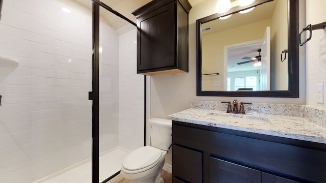 full bathroom with vanity, toilet, a ceiling fan, and a stall shower