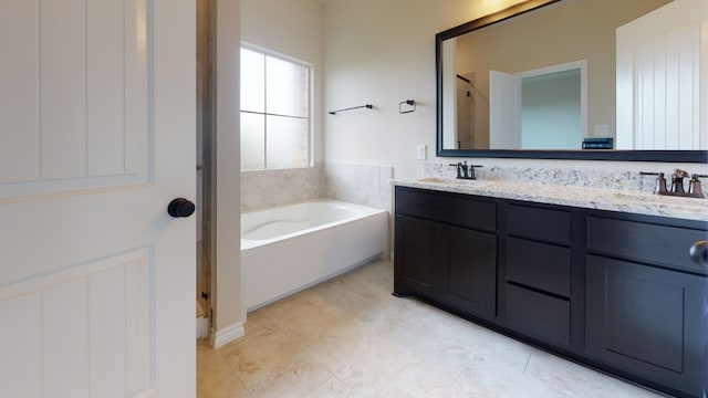 full bath featuring a sink, tile patterned flooring, double vanity, and a bath