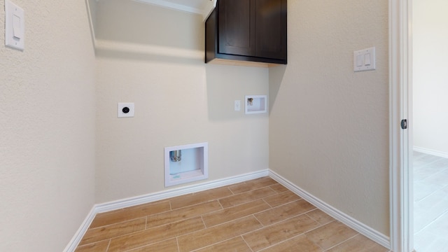 laundry room featuring cabinet space, washer hookup, light wood finished floors, electric dryer hookup, and baseboards