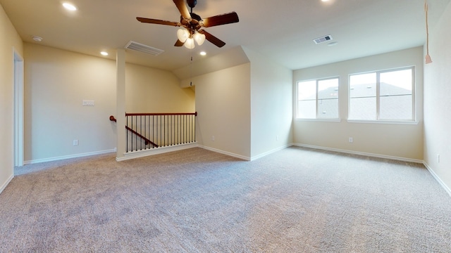 carpeted empty room with visible vents, a ceiling fan, baseboards, and recessed lighting